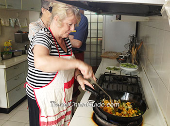 Learning to cook Chinese dishes at a local family