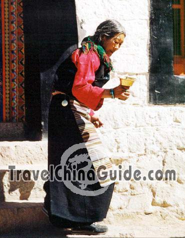Granny holding a butter lamp