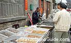 Snacks classified in different baskets are sold by retail in the street, Datong.