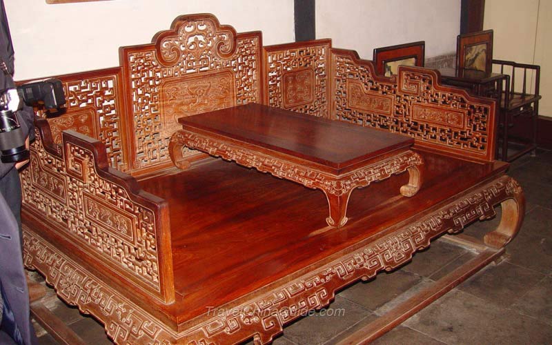 This is a piece of traditional Chinese furniture. People can sit or lie on it and put teaset on the middle teatable.
