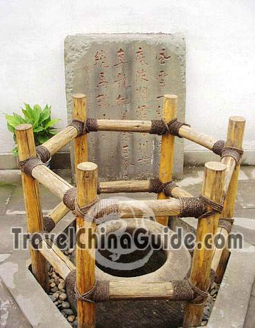 An ancient well is protected by wooden rails.