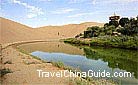 Crescent Lake is surrounded by the Echoing-Sand Mountain in Dunhuang.