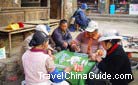Local people are playing mahjong (a puzzle game usually played by four persons).