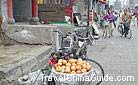 Apples put in the baskets at both sides of the backseat of a bicycle are for sale, Datong.