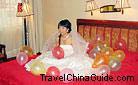 Beautiful bride is waiting for the bridegroom to meet her in a hotel. Generally speaking, bride should stay at her parents' home before the wedding ceremony, but nowadays some bride will stay at a luxurious hotel.
