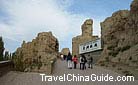 Visitors are going through the entrance to the Ancient City of Jiaohe.