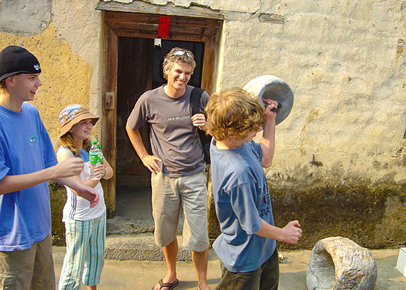 Children Try Lifting a Stone Farm Tool