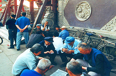 Retired people playing cards for amusement