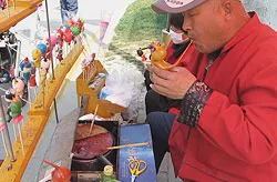 Blowing traditional Chinese sugar figurines
