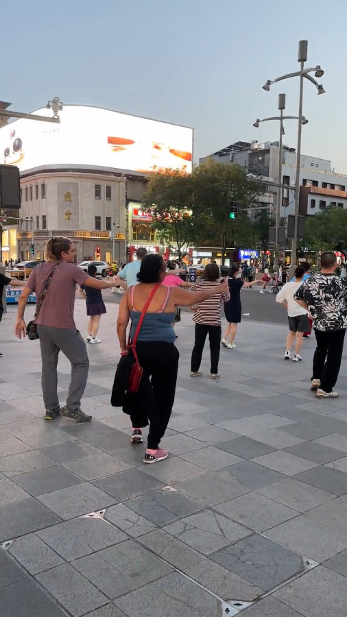 International Travelers Dancing with Locals 