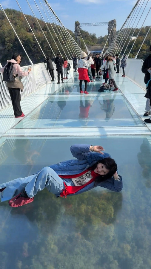 Visitors Lying down on Zhangjiajie Glass Bridge